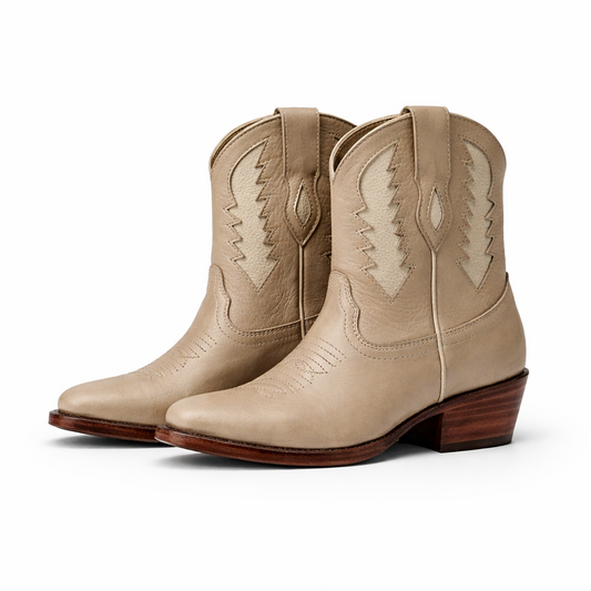 Pair of beige cowboy boots on a white background